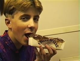 Chris Platt enjoying his 'exquisite cake' on the train at Ipswich station